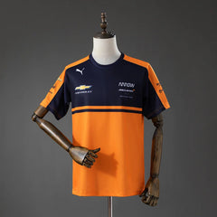 Camiseta del equipo McLaren de IndyCar 2026 en naranja y azul marino - vista frontal