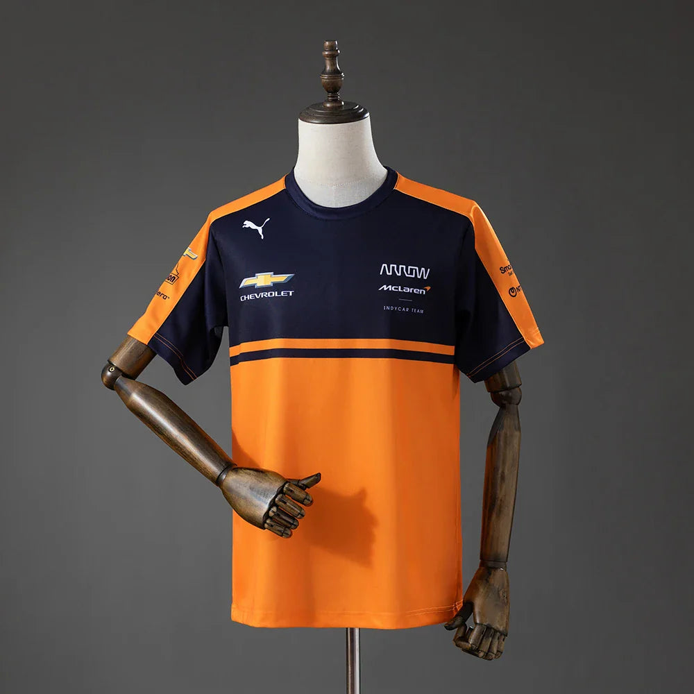 Camiseta del equipo McLaren de IndyCar 2026 en naranja y azul marino - vista frontal