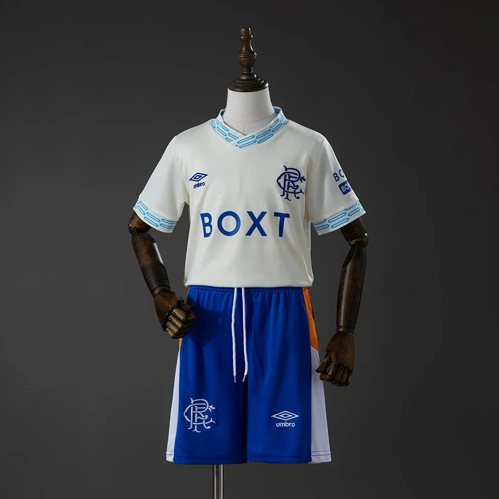 Conjunto infantil del Rangers segunda equipación 26/27 crema y azul - vista frontal