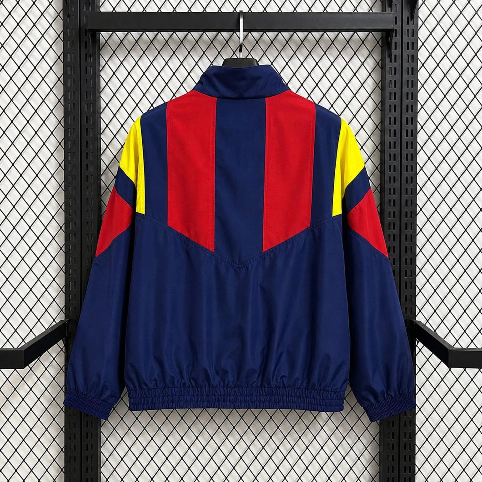 Chaqueta cortavientos España 2026 azul marino y rojo - vista trasera